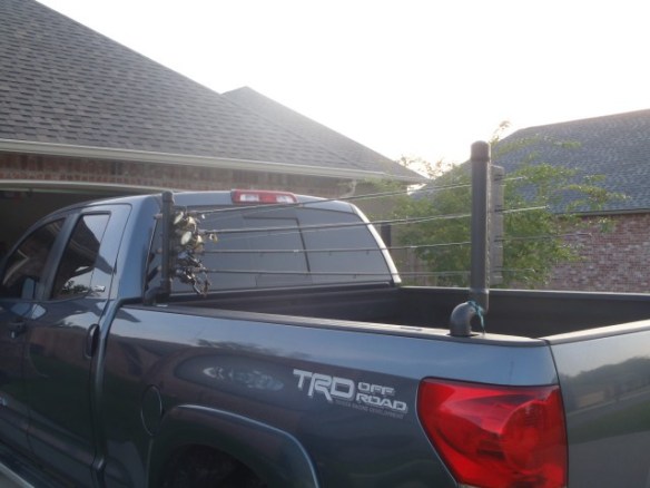 Fishing pole holder that uses car window to transport fishing poles